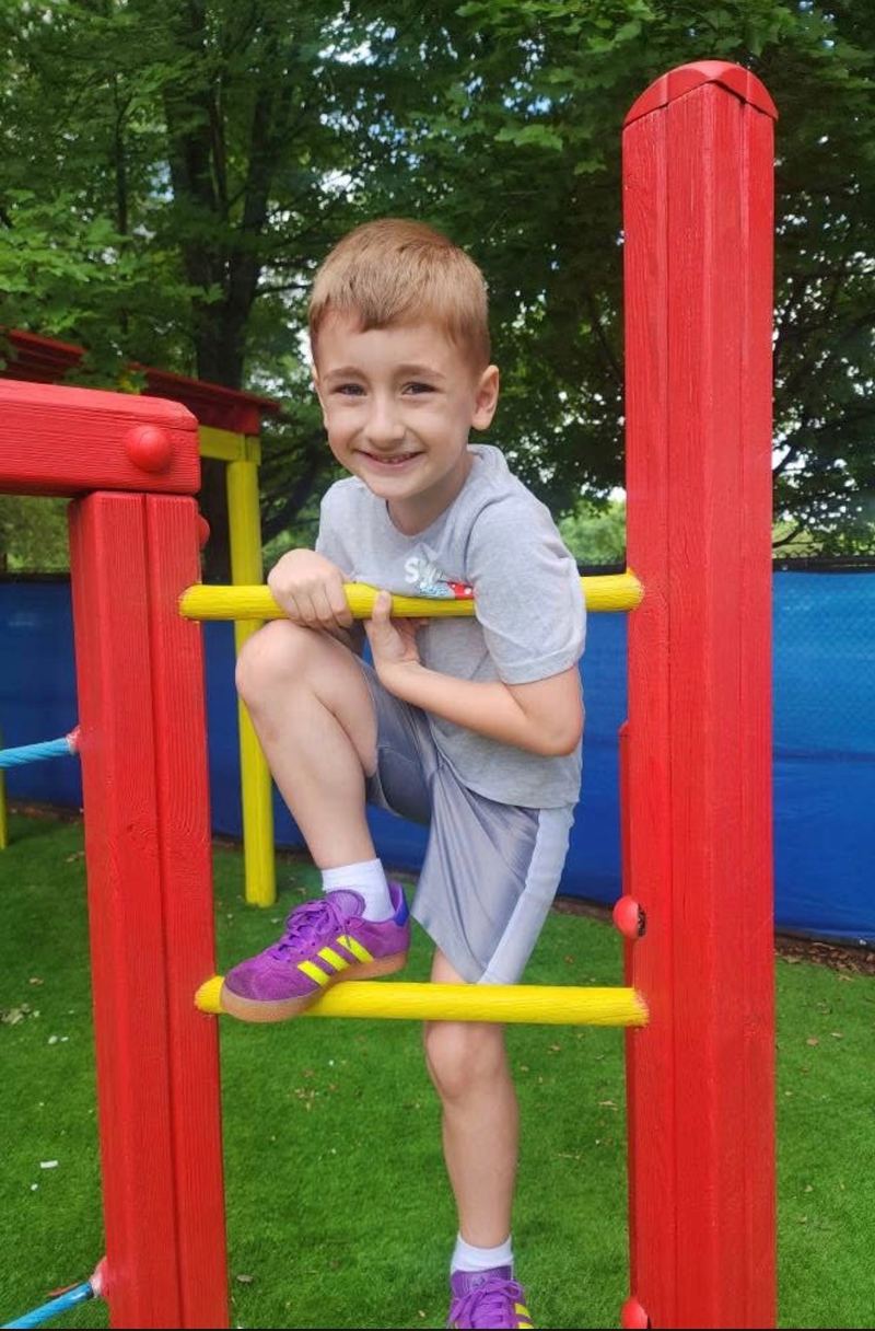 Climbing on the outdoor play structure.