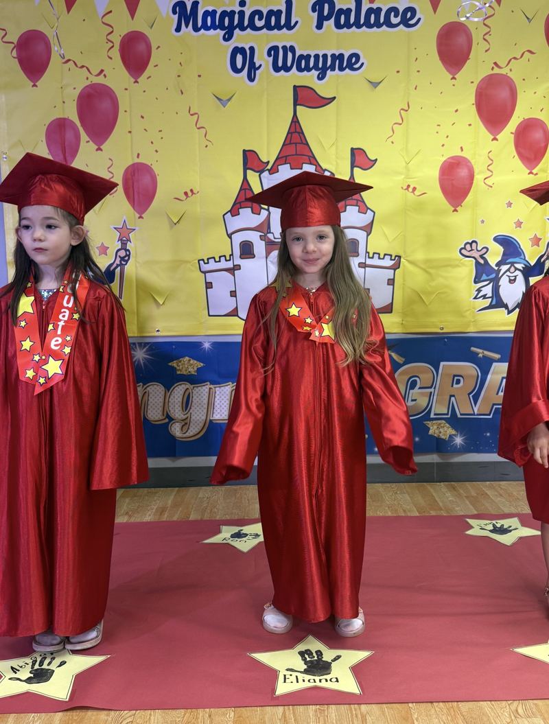 Graduates in caps and gowns at our graduation celebration.