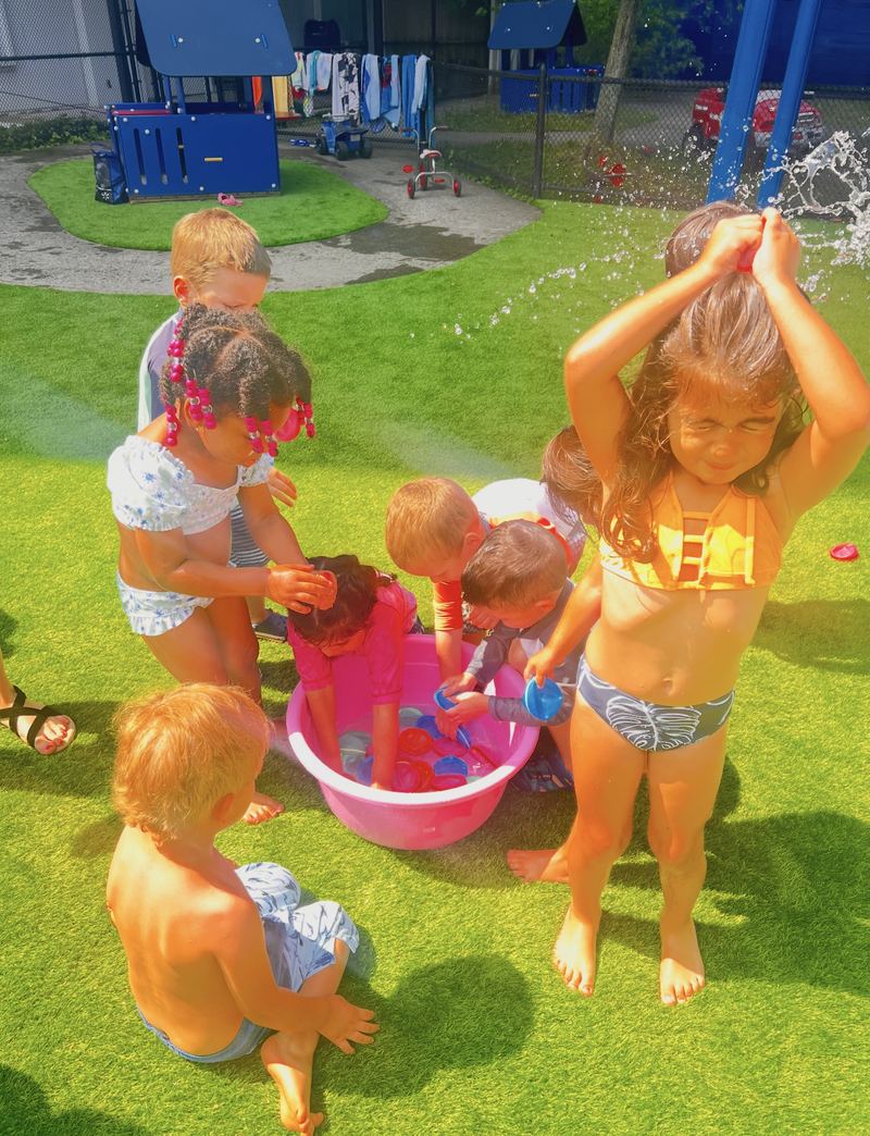 Water play on the grass on a sunny day.