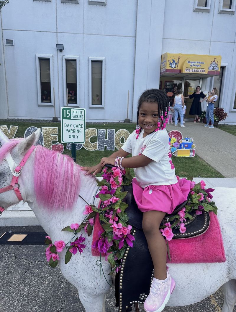 The front of our building and entrance canopy, with a 15-minute day care parking sign out front. On this day, a decorated pony was visiting.