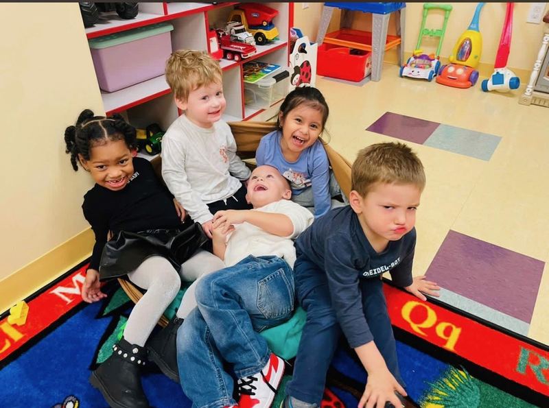 Friends together on the classroom rug.